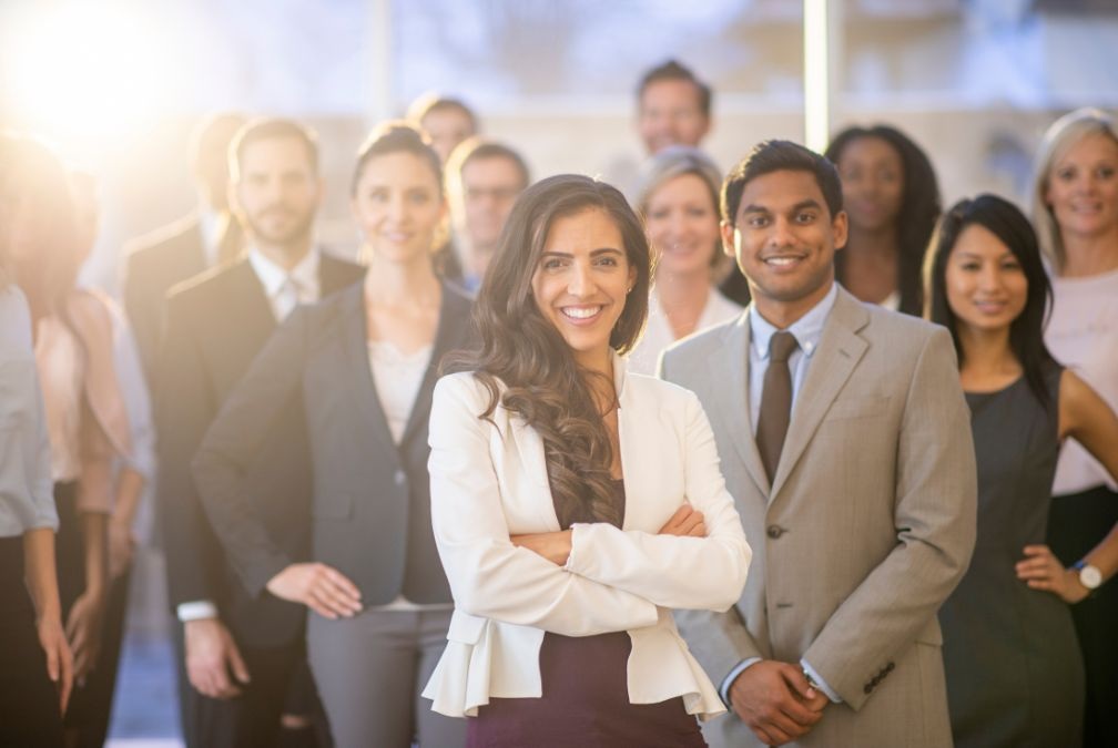 Group of happy and successful people smiling together, symbolizing how transformation impacts energy, confidence, purpose, and success in ways resolutions alone cannot achieve